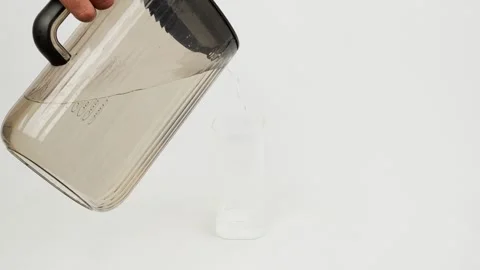 Clear Drinking Water Being Poured into a Glass Stock Footage 327852576