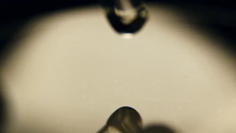 Clear drops fall down from dropper at bright backlight Stock Footage 236708632