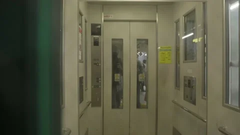 Clear elevator door comes down POV Stock Footage 229905535