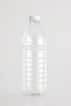 Clear empty plastic bottle with red lid isolated on white vertical shot 스톡 사진