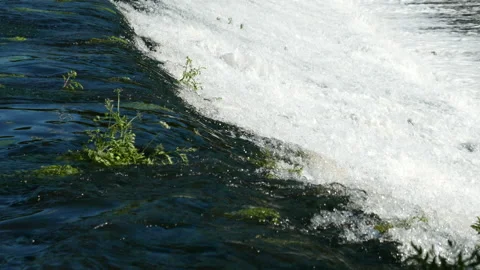 Clear, fast-flowing water flowing over Weir in river Ave, Portugal. Stock Footage 195895271