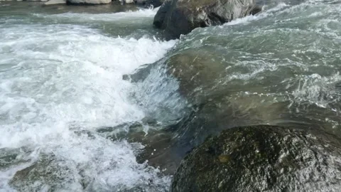 A clear flowing mountain river in the river rocks Stock Footage 320984893