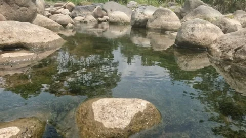 A clear flowing rocky mountain river Stock Footage 323149444