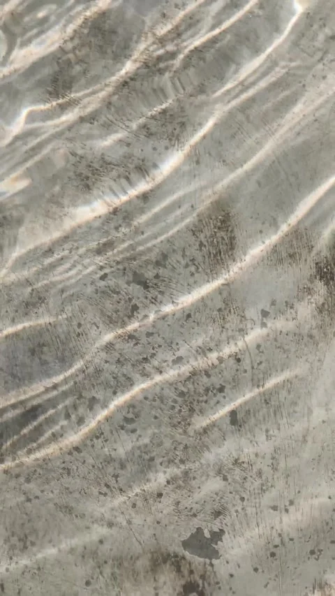 Clear flowing water surface with rhythmic ripples, sunlight refraction, cau.. Stock Footage 346659376