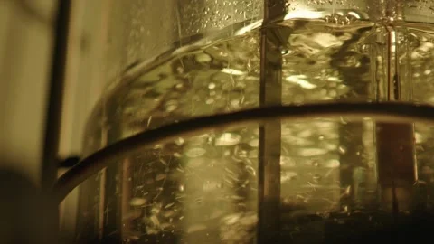 Clear fluid with bubbles is beeing mixed in medical laboratory, pharmacy concept Stock Footage 153475606