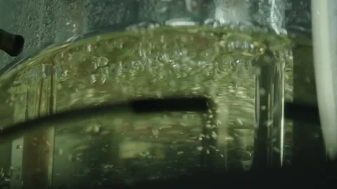 Clear fluid with bubbles is beeing mixed in medical laboratory, pharmacy concept Stock Footage 153475751