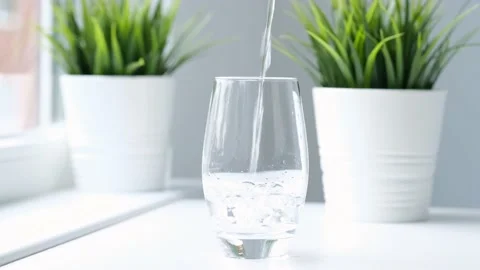 Clear fresh drinking water poured Into glass closeup. Slow motion. Pure water Video stock 234758348