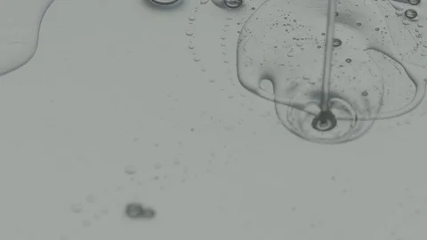 Clear Gel Pours into Grey Mixture Stock Footage 77780391