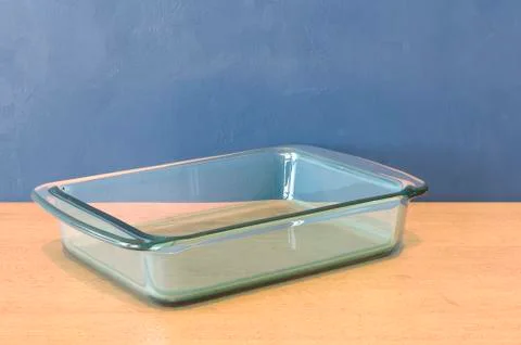 Clear Glass Baking Dish, rectangular shape on the wooden table. 3D rendering Stock Illustration