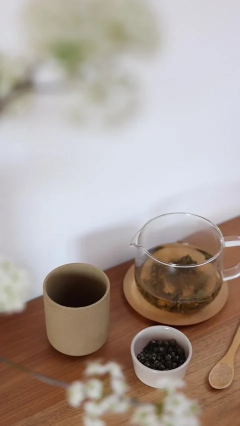 Clear Glass Teapot Ceramic Cup Tea Set Tabletop Presentation 4K Stock Footage 339268236
