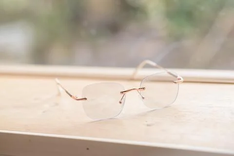 Clear glasses placed on a table next to a glass in a coffee shop. Stock Photos