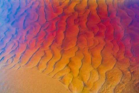 Clear golden water stream pattern with sand waves under it Stock Photos