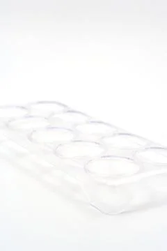 Clear ice cube tray on flat surface for making ice at home Stock Photos