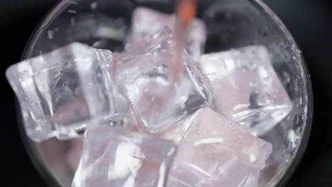 Clear Ice Cubes Scattered on Dark Surface Closeup Stock Footage 340123946