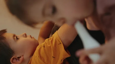 Clear image of a boy concentrating and doing his homework, in the blurred image Stock Footage 257542567