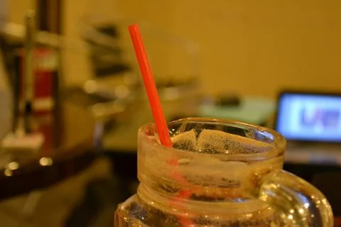 A clear jar and straw on the table Stock Photos