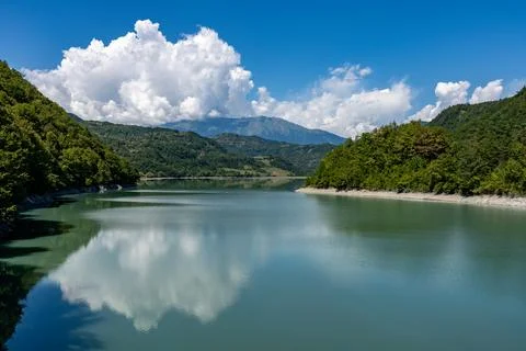 Clear lake in mountains with nice reflection of sky and clouds Stock Photos