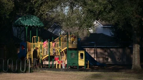 Clear Lake, TX, US - December 26, 2022:  Woman and children at a playground.  Stock-Footage 228524703