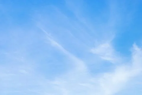 Clear light blue sky background with beautiful natural white fluffy clouds Stock Photos