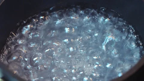 Clear liquid boiling with bubbles rising Stock Footage 318297707