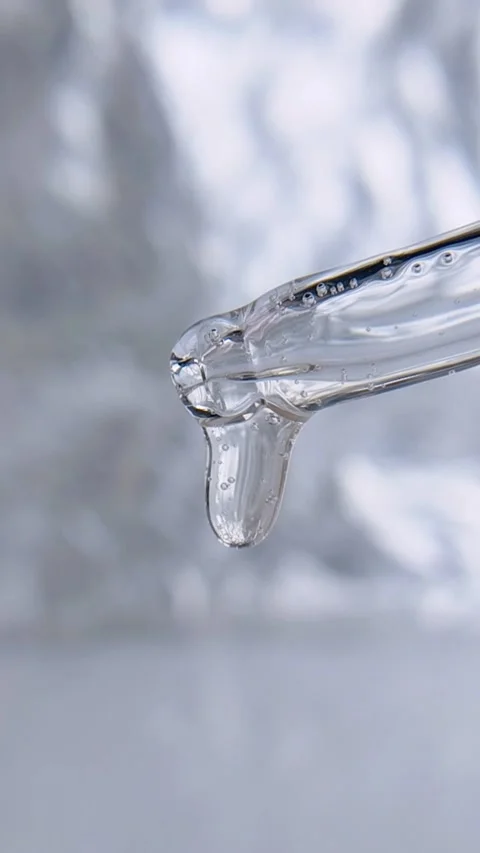 Clear liquid dripping from transparent pipette tip serum freshness concept Stock Footage 335296808