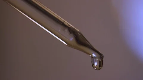 Clear liquid drops and squirts from eyedropper/pipette Stock Footage 82829020
