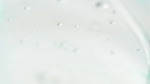 Clear Liquid Gel With Tiny Bubbles Mix With Green Serum And Slowly Gliding Stock Footage 138398648