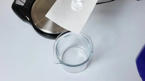 Clear Liquid in Glass Beaker on Laboratory Surface Stock-Footage 345259443
