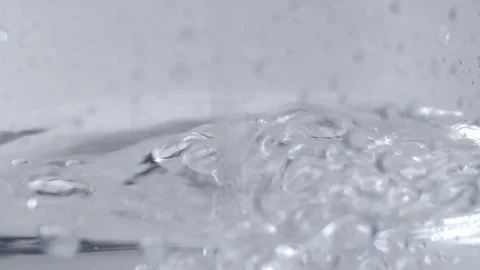 Clear liquid poured into a half full glass Stock Footage 114085481