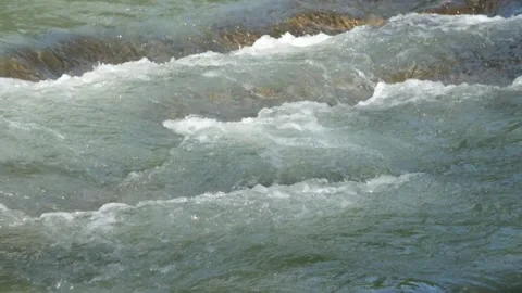 Clear mountain river cascade flowing over rocks in pristine natural landscape Stock-Footage 336878020
