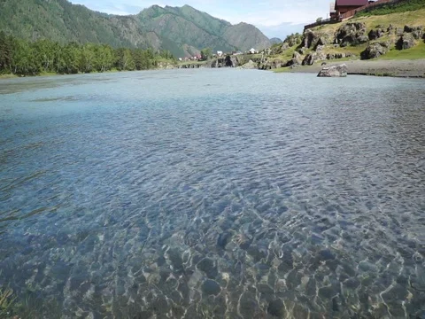 Clear mountain river with sun speckles on water Stock Footage 76642853