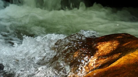 Clear mountain stream bubbles up. Stock Footage 98452556