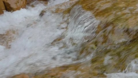 Clear Mountain Stream Cascading Over Moss-Covered Brown Rocks Stock Footage 342310331