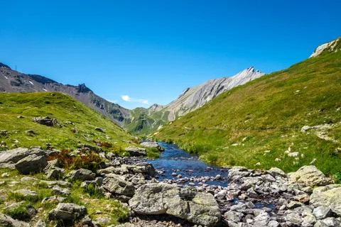 Clear mountain stream flowing in alpine valley, France Stock Photos