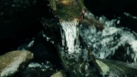 Clear Natural Water flows through the Bamboo in the river Stock-Footage 254015944