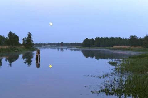 Clear night, moonlight, the reflection of the moon in the pond Stock Photos