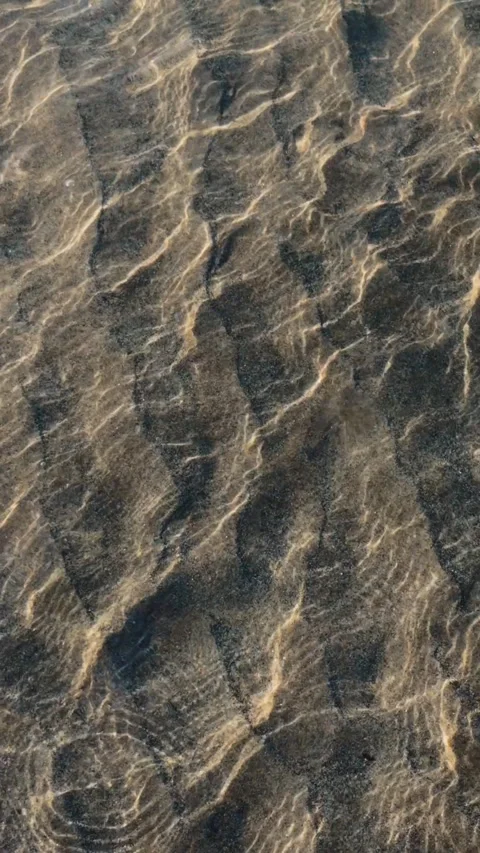 Clear ocean water creates a beautiful abstract pattern as light shimmers and Stock Footage 340959213