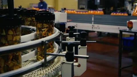 A Clear Packaged container with mixed snacks on a production line in a factory Stock Footage 155462521