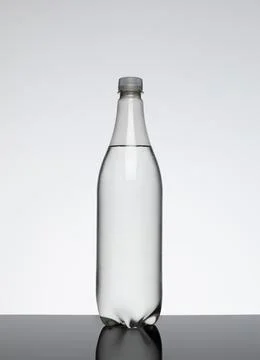 Clear plastic bottle with no label containing a clear liquid. Stock Photos
