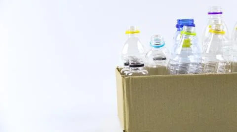 Clear plastic bottles on a white surface, awaiting recycling. Foto stock