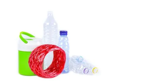 Clear plastic bottles on a white surface, awaiting recycling. Stock Photos