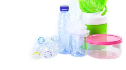 Clear plastic bottles on a white surface, awaiting recycling. Stock Photos
