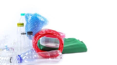 Clear plastic bottles on a white surface, awaiting recycling. Stock Photos