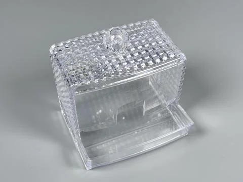 Clear plastic container with a lid for storage on a gray background Stock Photos
