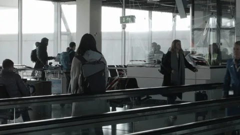 Clear Plastic Screen over desk in Airport as Airline Staff Dash By Stock Footage 127779177