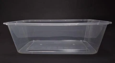 Clear plastic storage box rectangular shape, black background Foto stock