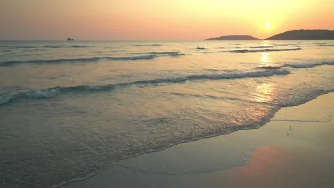 Clear ripple Waves on shore continuously on a wide beach Stock Footage 240722993