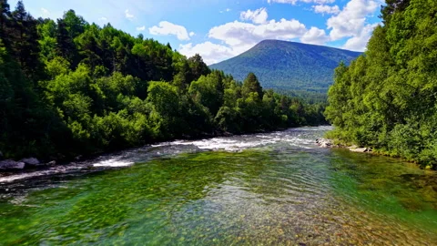 Clear River Flow beneath Mountain Ridge, Oppdal Norway Stock Footage 318532662