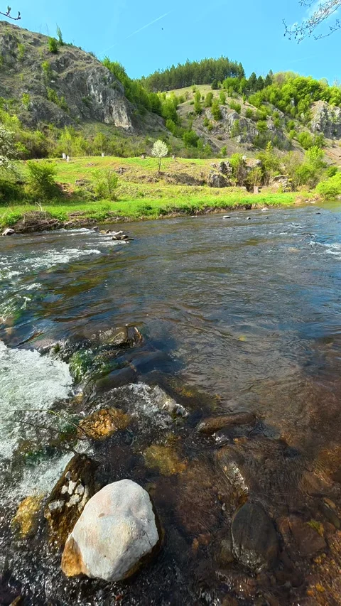 Clear river flows past mossy rocks. Bigar Waterfall, Serbia. Vertical Видео 333700678