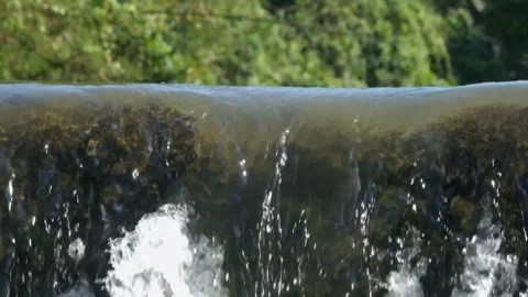 The clear river flows through the dam Video stock 280391275